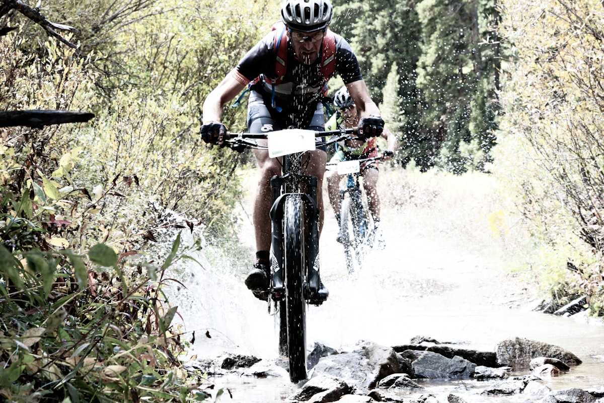 Cyclists pushing hard on a demanding route — sustained effort builds the aerobic base that endurance racing demands