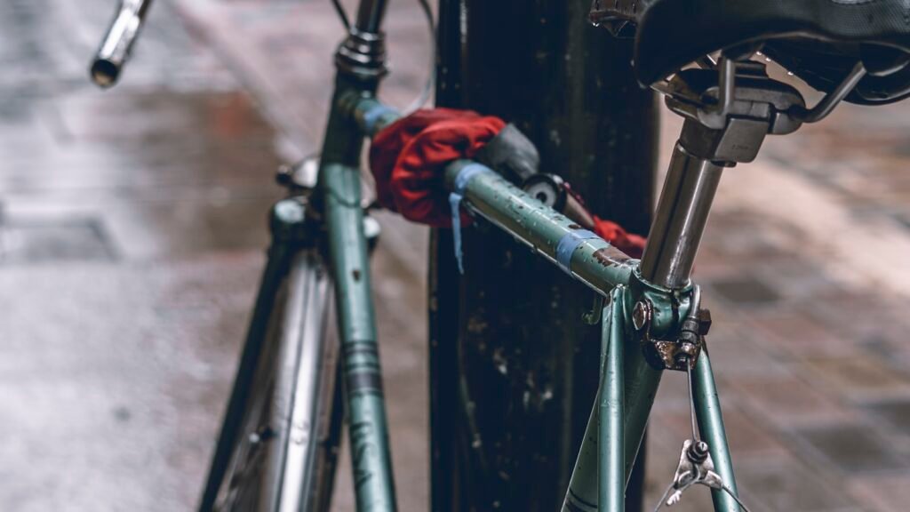 Bicycle locked to a post with a U-lock in an urban setting