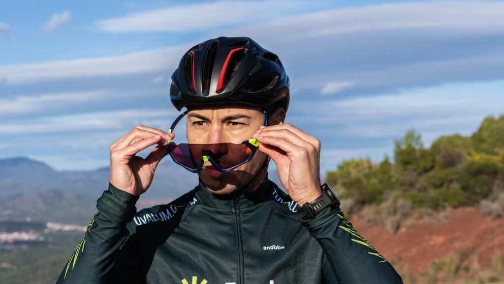 Cyclist wearing sunglasses and helmet on a road