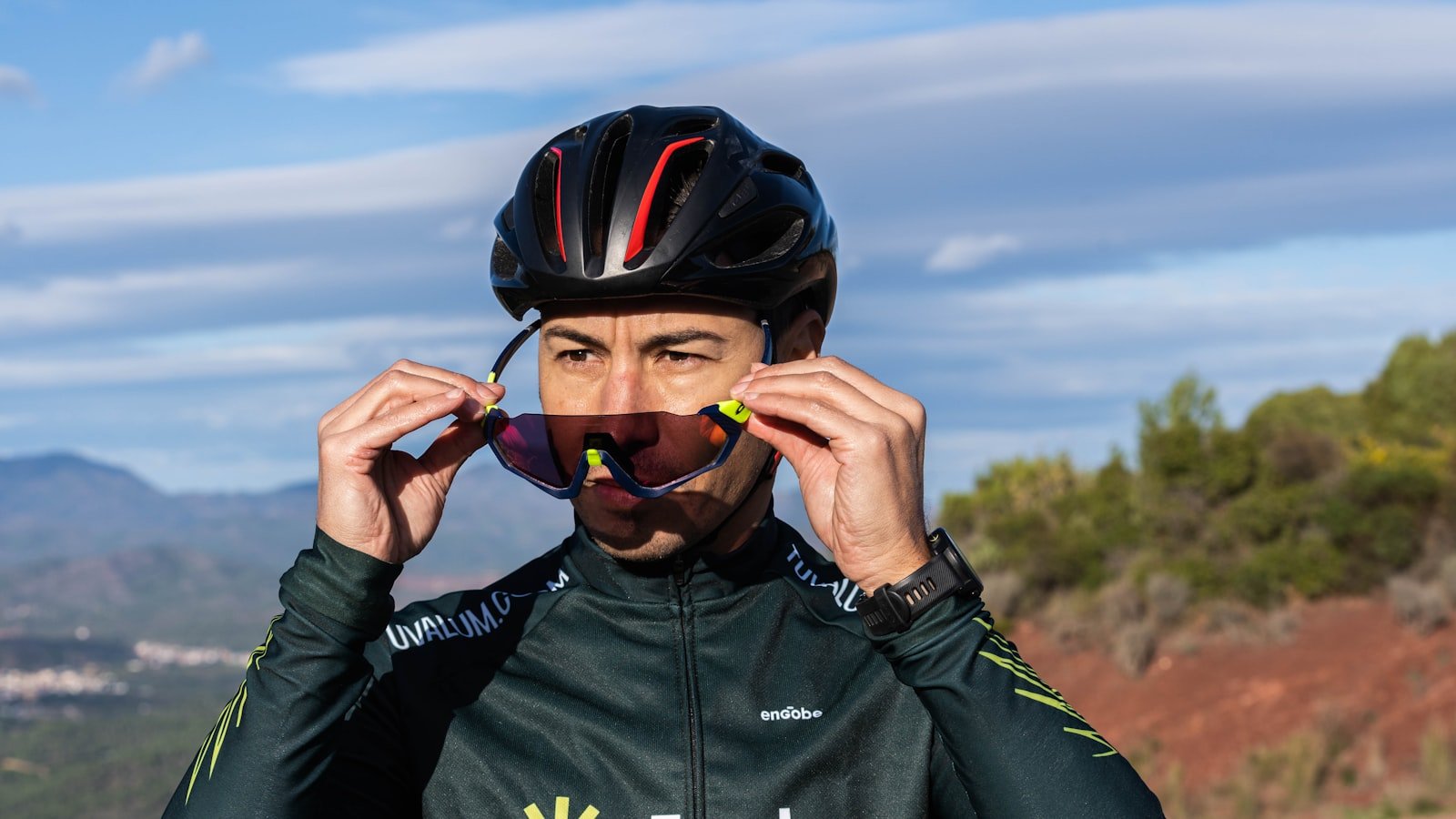 Cyclist wearing sunglasses and helmet, close-up